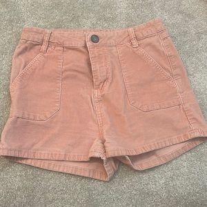 Pink corduroy shorts with pockets in the front and back